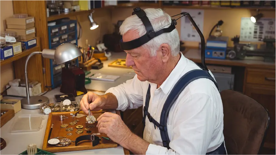 Watchmaker using a neck support exoskeleton for precision repair work